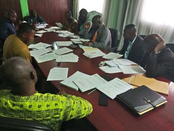 Members of the NDMA Board examining documents